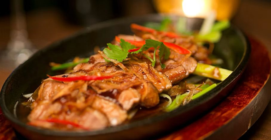 Duck in tamarind sauce served on a sizzling hot plate